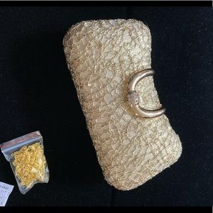 Gold vine detailing and blinged out buckle evening bag. Gold tone chain strap